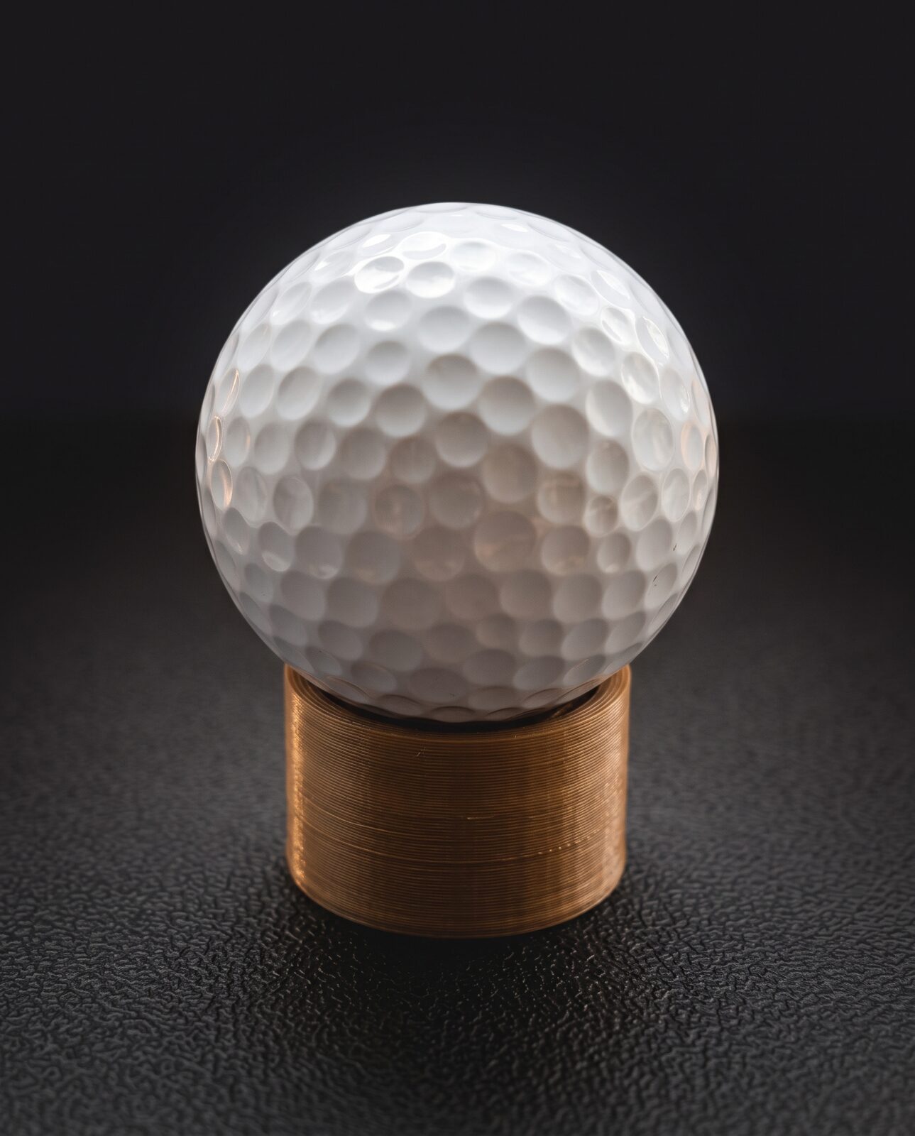 Dimple¹ stamp: a rescued golf ball handle seated on a wood-toned 3D-printed PLA housing
